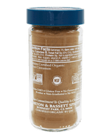 A clear plastic jar of Morton & Bassett Spices non-cinnamon organic ground spices, featuring a blue screw cap and a white label with black text.