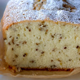 Loaf of cake with powdered sugar on top, close-up view
