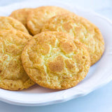 Round cookies on a white plate with a light blue background