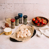 Scallops on a plate with ingredients and spices on a marble surface