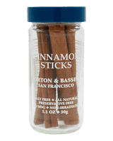 Jar of cinnamon sticks with a blue lid and clear label 