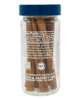 Jar of cinnamon sticks with blue lid and visible brand information