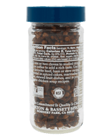 Jar of black peppercorns with a blue lid and visible label