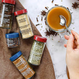 Spices and a mug of hot beverage on a marble surface