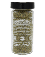 A clear spice jar with a black lid containing dried oregano leaves. The label includes nutritional information and is marked as gluten-free and kosher.