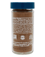 Glass jar of Morton & Bassett ground nutmeg with blue lid, detailed label text, and certifications for quality and dietary standards.