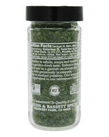 A clear plastic jar of Parsley & Scallion Seasoning by Rohnert Park Spices, showing chopped green herbs inside, with a black lid and a black label displaying nutrition facts and NSF certification logos.