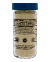 A clear plastic bottle of Morton & Bassett Spices seasoned white pepper with a blue cap, shown against a solid black background. The front of the bottle features a white label with black text displaying the brand, product type, and nutritional facts.