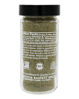A clear plastic spice jar filled with dried green herbs, featuring a black screw cap and a white label with text, photographed against a solid black background. The label shows NSF Certified Non-GMO and USDA Organic logos, and the brand name 'Pittson & Bassett Spices' is visible at the bottom.