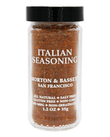 A clear plastic spice jar filled with Morton & Basset Italian Seasoning, featuring a black lid and white text