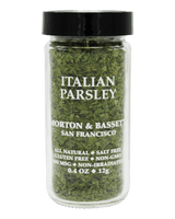 A clear glass jar of Morton & Bassett Italian Parsley with a black lid, shown against a solid black background. The white text on the front clearly displays the brand and product name.