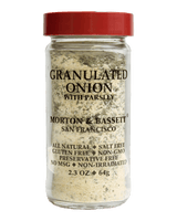 A clear glass jar of Morton & Bassett Granulated Onion with Parsley, featuring a red lid and black text
