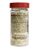 A clear plastic spice jar with a red lid, showing the back of the label with nutrition facts and product details for Morton & Bassett Spice Granulated Onion.