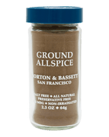 A jar of Morton & Bassett Ground Allspice against a solid black background. The product is in a clear glass jar showing the brown spice powder inside, topped with a blue screw cap.