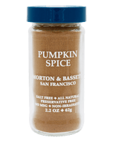 A clear plastic spice jar filled with pumpkin spice seasoning, featuring a blue screw-top lid and white text on the front label that reads 'PUMPKIN SPICE' and 'MORTON & BASSET SAN FRANCISCO'. 