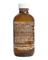 An amber glass bottle of Morton & Bassett Almond Extract with a white cap, shown against a solid black background. The front label is turned sideways to display the Nutrition Facts panel.