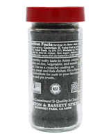 A clear plastic bottle of Asian-inspired seasoning mix with a bright red cap, shown against a solid black background. The back of the bottle features white text detailing the nutrition facts and ingredients