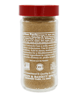 A clear plastic spice jar filled with brown ground spice, featuring a red lid and white printed nutrition facts and product details on the back