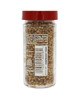 A clear spice jar with a red lid filled with whole coriander seeds. The label shows nutritional information and a barcode.
